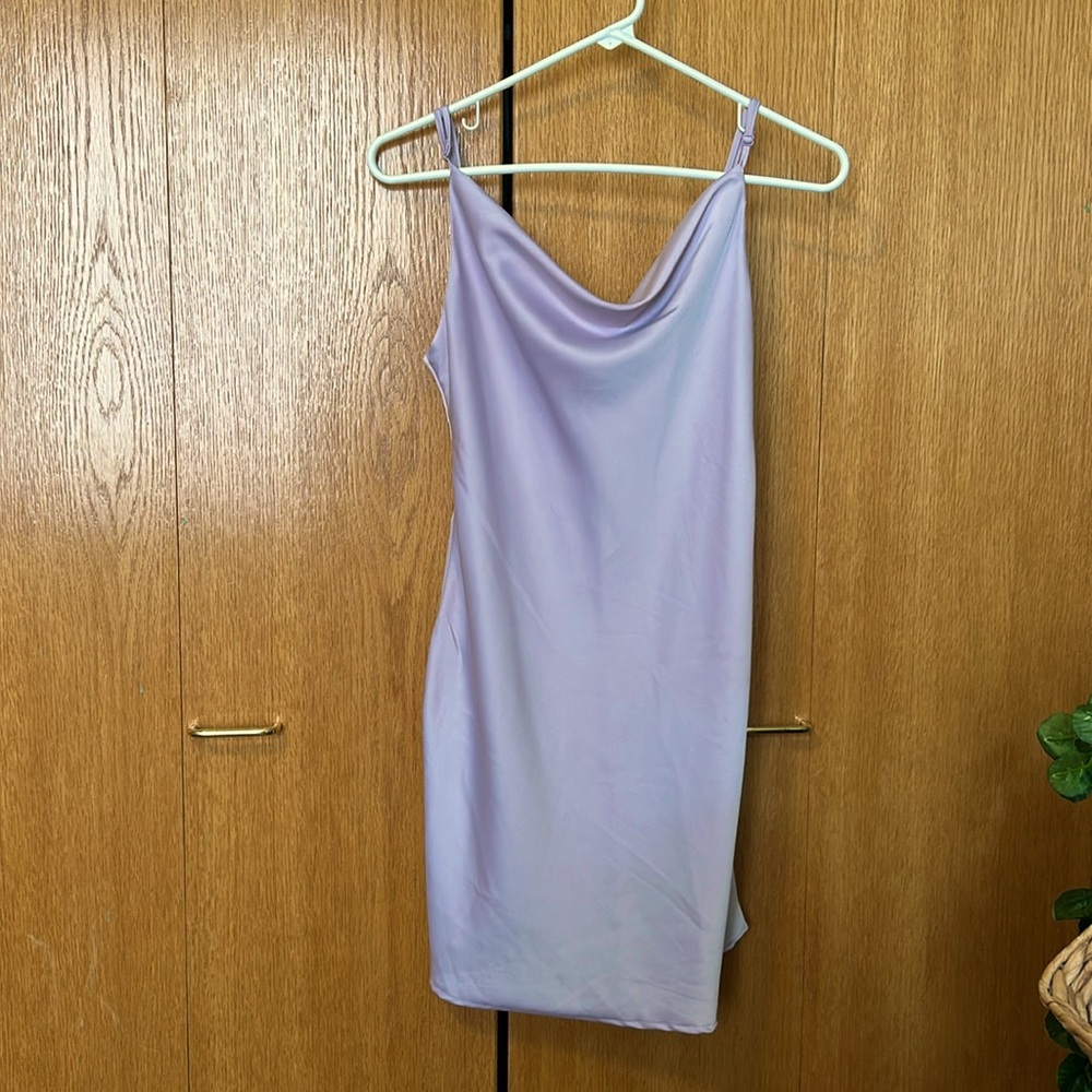 Purple satin dress that goes to mid thigh depending on height.